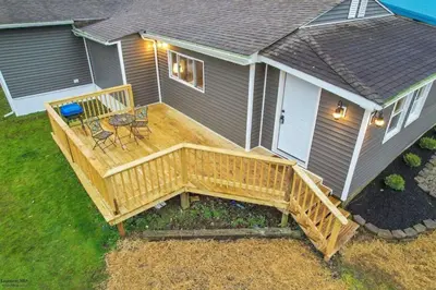 a large wooden deck on the side of a house at Corporate Cottage on Circle in Thornville