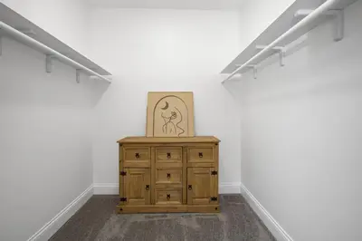 a room with a wooden dresser and a picture on the wall at Victorian Villa in Columbus