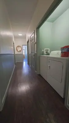 an empty room with a kitchen and a hallway at Lincoln House Inn in Bowling Green