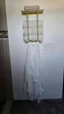 a towel rack with towels on a wall in a bathroom at Lincoln House Inn in Bowling Green