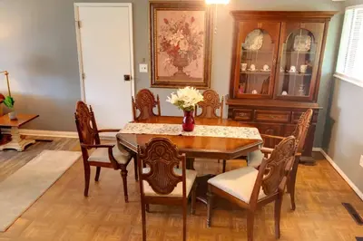 a dining room with a table and chairs at 3BR Home, Pet-Friendly, Fenced Yard Near I-70, I-75, Hospitals, Wright-Patt AFB in Dayton