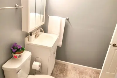 a bathroom with a white toilet and a sink at 3BR Home, Pet-Friendly, Fenced Yard Near I-70, I-75, Hospitals, Wright-Patt AFB in Dayton