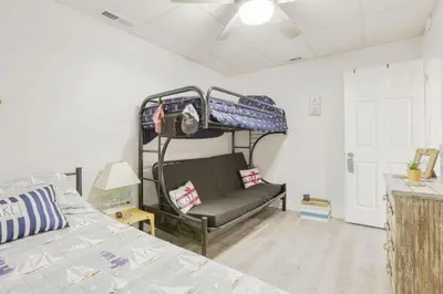 a bedroom with a bed and a chair in a room at Quaint Cottage in Thornville