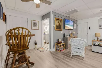 a living room with a chair and a table at Quaint Cottage in Thornville