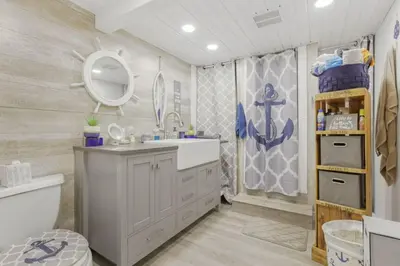 a bathroom with a sink and a toilet and a mirror at Quaint Cottage in Thornville