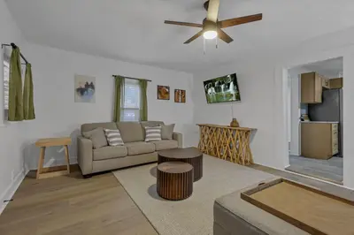 a living room with a couch and a ceiling fan at Mirror Pond Cabins in Rockbridge