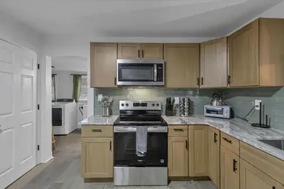 a kitchen with a stove and a microwave at Mirror Pond Cabins in Rockbridge