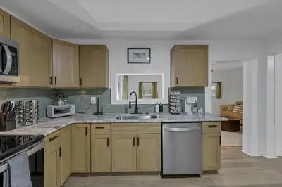 a kitchen with wooden cabinets and a sink at Mirror Pond Cabins in Rockbridge