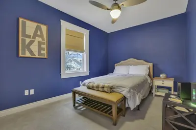 a blue bedroom with a bed and a window at The Lakehouse in Buckeye Lake
