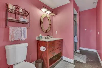 a pink bathroom with a toilet and a sink at The Lakehouse in Buckeye Lake
