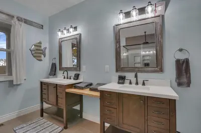 a bathroom with two sinks and a mirror at The Lakehouse in Buckeye Lake
