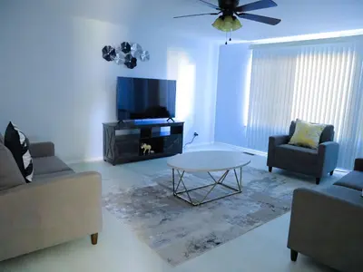 a living room with a tv and a table and chairs at A Nice and Cozy Home in Fairborn in Fairborn