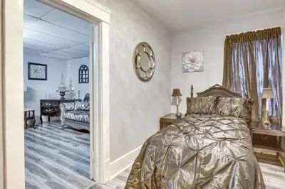 a bedroom with a bed and a room with a table at Canton Condo Near Football Hall of Fame and Dtwn! in Canton