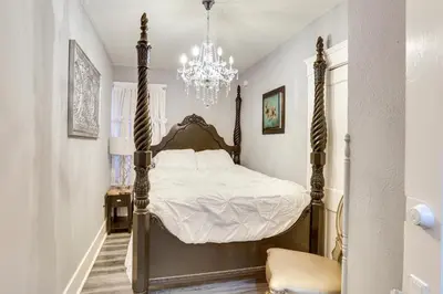 a bedroom with a canopy bed and a chandelier at Canton Condo Near Football Hall of Fame and Dtwn! in Canton