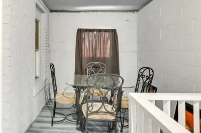 a table and chairs sitting on a porch at Canton Condo Near Football Hall of Fame and Dtwn! in Canton