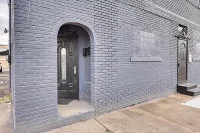 a blue brick building with a black door at Canton Condo Near Football Hall of Fame and Dtwn! in Canton