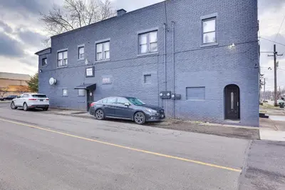 a blue building with two cars parked in front of it at Canton Condo Near Football Hall of Fame and Dtwn! in Canton
