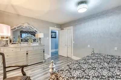a bedroom with a bed and a dresser and a mirror at Spacious Condo 4 Mi to Pro Football Hall of Fame! in Canton