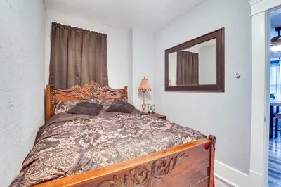 a bedroom with a bed and a mirror at Spacious Condo 4 Mi to Pro Football Hall of Fame! in Canton