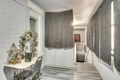 a hallway with a table and a curtain at Spacious Condo 4 Mi to Pro Football Hall of Fame! in Canton