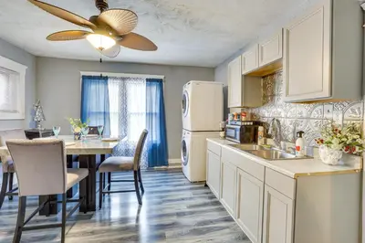 a kitchen with a table and a white refrigerator at Spacious Condo 4 Mi to Pro Football Hall of Fame! in Canton