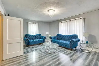 a living room with two blue couches and a table at Spacious Condo 4 Mi to Pro Football Hall of Fame! in Canton