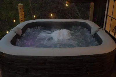 a jacuzzi tub filled with snow in a yard at Liv's Treehouse-Honeymoon Suite-Hot Tub in Milroy