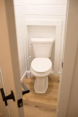 a bathroom with a white toilet in a room at Liv's Treehouse-Honeymoon Suite-Hot Tub in Milroy