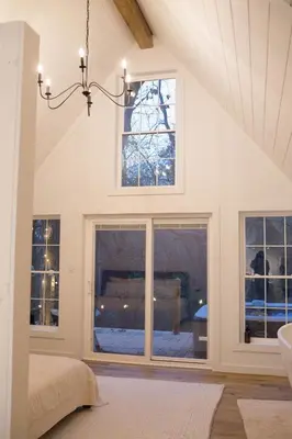a bedroom with a bed and a large window at Liv's Treehouse-Honeymoon Suite-Hot Tub in Milroy