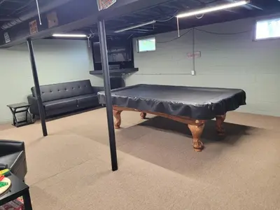 a room with a bed in a room with a couch at Perrysburg On The River in Perrysburg