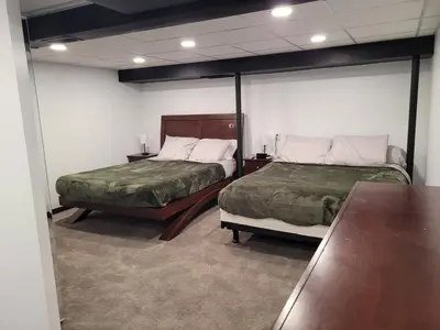a room with two beds and two tables in it at Perrysburg On The River in Perrysburg