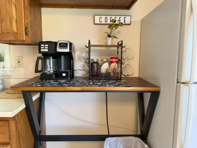 a table in a kitchen with a coffee maker on it at Avon Nature Retreat by Creek in Avon