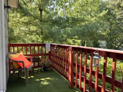 a patio with a table and a chair on a porch at Avon Nature Retreat by Creek in Avon