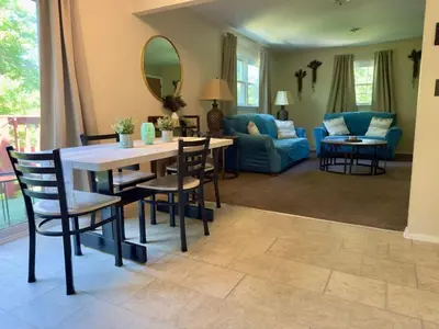 a living room with a table and chairs and a couch at Avon Nature Retreat by Creek in Avon