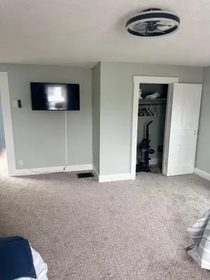 a living room with a flat screen tv on a wall at 3 bed room 5 beds 1 bath sleeps 6 guest in Hamilton