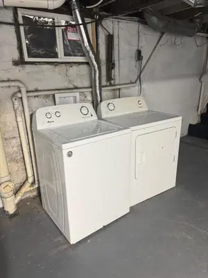 a washer and dryer sitting in a garage at 3 bed room 5 beds 1 bath sleeps 6 guest in Hamilton
