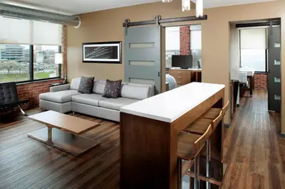 a living room with a couch and a table at Courtyard by Marriott Akron Downtown in Akron