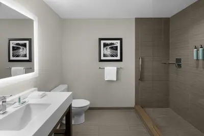 a bathroom with a sink and a toilet and a shower at Courtyard by Marriott Akron Downtown in Akron