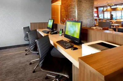 an office cubicle with three computers on a desk at Courtyard by Marriott Akron Downtown in Akron