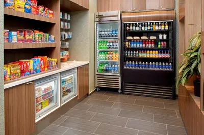 a grocery store aisle with a refrigerator and drinks at Courtyard by Marriott Akron Downtown in Akron