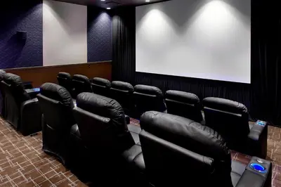 a cinema room with black chairs and a white screen at Courtyard by Marriott Akron Downtown in Akron