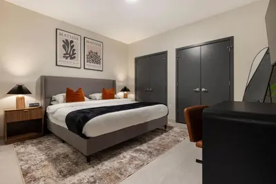 a bedroom with a large bed with orange pillows at Resort Style Property 2B 2B walk to Everything! in Cleveland