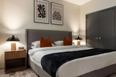 a bedroom with a large bed with orange pillows at Resort Style Property 2B 2B walk to Everything! in Cleveland
