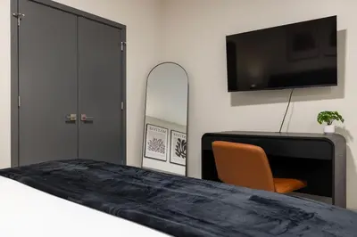 a bedroom with a bed and a tv and a chair at Resort Style Property 2B 2B walk to Everything! in Cleveland