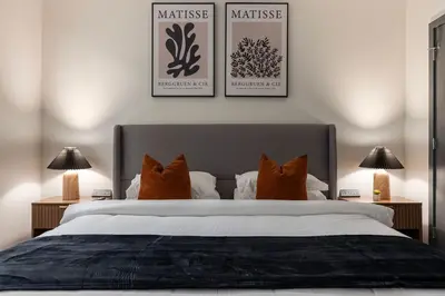a bedroom with a large bed with three pictures on the wall at Resort Style Property 2B 2B walk to Everything! in Cleveland