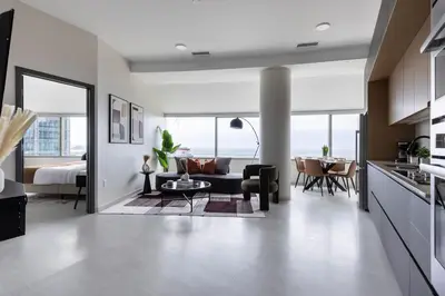 a kitchen and living room with a couch and a table at Luxury Downtown King Bed, Rooftop Pool in Cleveland