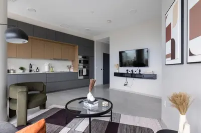 a living room with a couch and a table at Luxury Downtown King Bed, Rooftop Pool in Cleveland