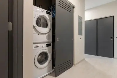 a laundry room with a washer and a washing machine at Luxury Downtown King Bed, Rooftop Pool in Cleveland