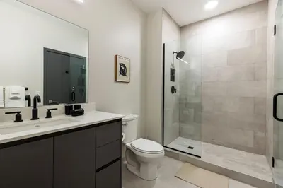 a bathroom with a toilet sink and a shower at Luxury Downtown King Bed, Rooftop Pool in Cleveland