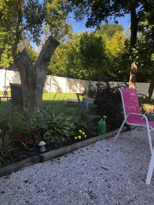 a yard with a pink chair and a tree at Suite Serenity in Cleveland